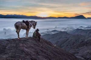 Man and Horse Resting at Sunrise